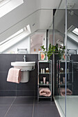 Modern attic bathroom with wall mounted basin in South London Victorian terraced house
