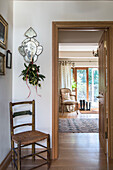 Wicker chair and Christmas garland at doorway in East Sussex coach house  England  UK