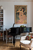 baby grand piano and art nouveau artwork with armchair in North London Victorian house  England  UK