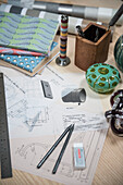 Pencil sketches with notebooks on desk in Oxfordshire barn conversion  England  UK