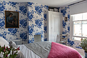 Blue and white floral wallpaper in bedroom of terraced house in Whitstable   Kent  England  UK