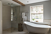 Walk in shower with freestanding bath in window of Grade II Listed priory  Headcorn  Kent  UK