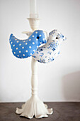 Fabric birds in contrasting blues on cream candlestick in Brighton home East Sussex England UK
