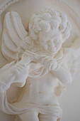 Winged cherub statue in Brighton home, East Sussex, England, UK