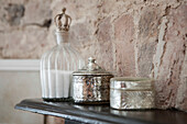 Vintage silver caskets and bath salts on shelf in Brighton home, East Sussex, England, UK