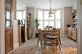 Wooden table and chairs in dining room of Brighton home, East Sussex, England, UK