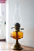 Vintage oil burner on windowsill in Devon cottage England UK