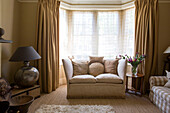 Neutral Living room with sofa and bay window in Edwardian West Sussex townhouse England UK