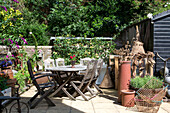 Courtyard garden with vintage fishing accessories Edwardian West Sussex townhouse England UK