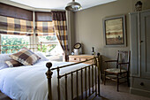 Brass bed with co-ordinated fabrics in Edwardian West Sussex townhouse England UK