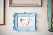 Butterfly made from an old china plate in a light blue frame West Sussex beach house UK