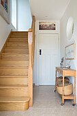 Wooden stairs and console in hallway of West Wittering home West Sussex England