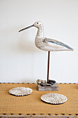 Wooden painted seagull and coasters in West Wittering home West Sussex England