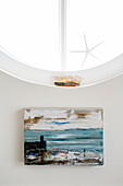 Art canvas and porthole window in West Wittering home West Sussex England