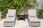Matching grey recliners on patio of West Wittering home West Sussex England