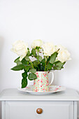 Cut white roses in floral jug West Wittering home West Sussex England