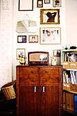 Vintage radio on wooden cabinet with filing shelves in Birmingham home  England  UK