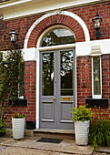 Arched double door of detached brick London home  England  UK