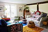 Variety of fabrics and patterns in timberframed living room of Brabourne farmhouse,  Kent,  UK