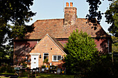 Tiled roof and brick facade of Brabourne farmhouse,  Kent,  UK