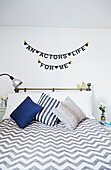 'An actors life for me' bunting above bed in Faversham home,  Kent,  UK