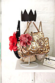 Floral accessories on gold sequinned handbag in Faversham home,  Kent,  UK