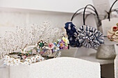 Beaded and jewelled accessories with floral brooch in Faversham home,  Kent,  UK