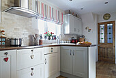 Striped roman blinds in open plan kitchen of Bolton home,  Greater Manchester,  England,  UK