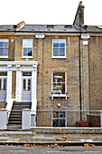 Railings and steps in front of three-storey London townhouse  England  UK