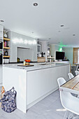 White fitted open plan kitchen in London townhouse  England  UK
