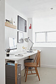 Desk and chair at window in modern London apartment  UK