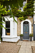 Front door and bay window with paved footpath and gravel forecourt  London home  England  UK