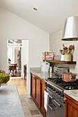 Copper saucepan on hob in farmhouse kitchen of London home  UK