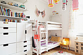 Assorted lanterns and bunk bed with lit lamp in child's room of Sheffield home  Yorkshire  UK