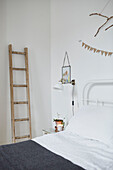 Ladder and lamp at bedside in London home  UK