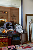 Letter 'G' and clock with collection of vintage ornaments and large mirror in Rochester hallway  Kent  UK