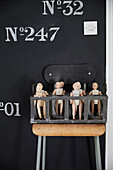 Dolls in crate on vintage chair in Rochester home  Kent  UK
