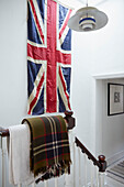 Union Jack and blanket with pendant light on Rochester staircase banister  Kent  UK