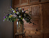 Vintage flower arrangement with wooden storage in London home  UK