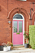 Pink front door to Victorian two-storey red brick Lancashire home  England  UK