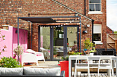 Decked terrace with awning in garden of modernised Victorian Preston home  Lancashire  England  UK