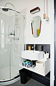 Washbasin and shower cubicle in modernised Preston home  Lancashire  England  UK