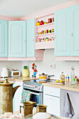 Saucepan on electric hop in light blue kitchen of East Riding of Yorkshire home  England  UK