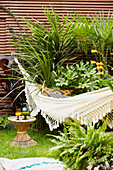 Cream hammock and plants in East London garden  England  UK