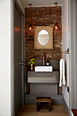 Vintage mirror above washbasin in East London townhouse  England  UK