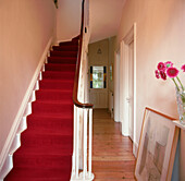 Hallway with bright red carpet runner in Victorian home