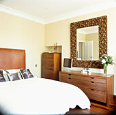 Double bedroom with bespoke walnut chest of drawers and ornate mirror frame