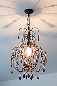 Decorative jewelled ceiling light in bedroom of New Malden home, Surrey, England, UK