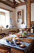 Placemats and lunch dishes on table in kitchen of watermill conversion