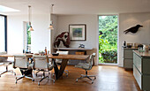 Chrome and leather chairs at wooden dining table with animal sculptures in Essex home UK